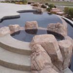 A swimming pool with large rocks