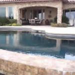 A swimming pool with large rocks
